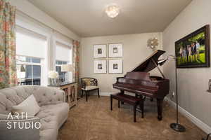 Sitting room with carpet, a textured ceiling, and baseboards