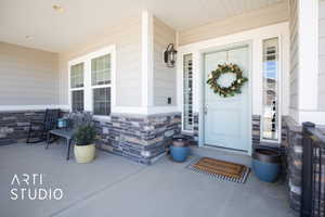 Doorway to property featuring stone siding