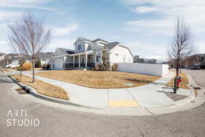 View of front of property featuring concrete driveway, an attached garage, fence, and a residential view