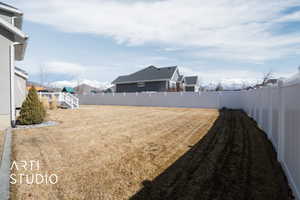 View of yard featuring a fenced backyard and a mountain view