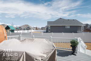 Wooden terrace featuring a fenced backyard and a residential view