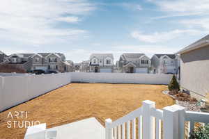 View of yard with a fenced backyard and a residential view