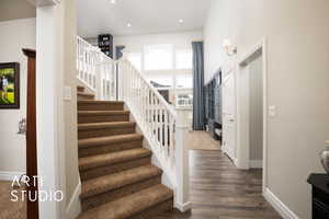 Stairway featuring recessed lighting, baseboards, and wood finished floors