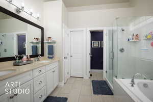 Full bathroom featuring a garden tub, double vanity, a sink, and a shower stall