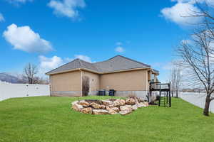 View of home's exterior with a wooden deck, a lawn, and central air condition unit