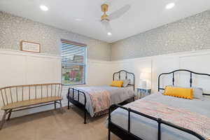 Carpeted bedroom with ceiling fan