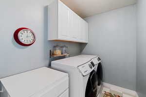 Clothes washing area with cabinets and washing machine and clothes dryer