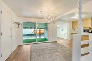 Interior space featuring wood-type flooring and an inviting chandelier