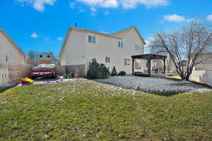 Back of house with a gazebo, a yard, a deck, and a pergola