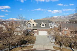 Front of property with a garage and a mountain view