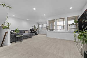 Living room featuring light colored carpet