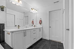 Bathroom with vanity, tile patterned flooring, and a textured ceiling