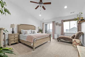 Carpeted bedroom featuring lofted ceiling, access to exterior, and ceiling fan