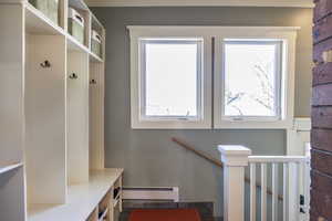 Mudroom featuring a baseboard radiator and a healthy amount of sunlight