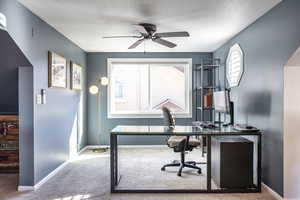 Carpeted office with ceiling fan