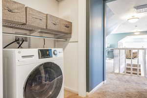 Clothes washing area with washer / clothes dryer and light carpet