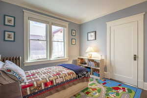 Bedroom featuring radiator and ornamental molding