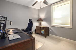 Carpeted office space featuring ceiling fan