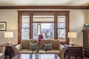 Living room featuring a wealth of natural light and ornamental molding