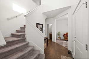 Entrance foyer with dark hardwood / wood-style floors