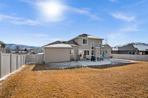 Rear view of property featuring a mountain view and a patio area