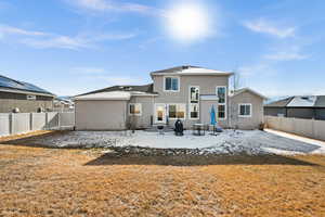 Back of property featuring a yard and a patio area