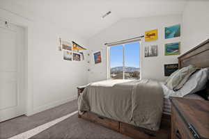 Carpeted bedroom with a mountain view and lofted ceiling