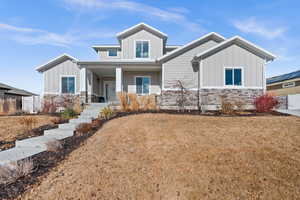 Craftsman-style house with a front lawn and covered porch