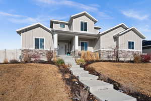 View of front of house featuring a porch and a front lawn