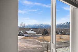 Doorway to outside featuring a mountain view and a healthy amount of sunlight