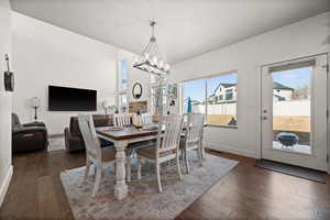 Dining room featuring dark hardwood / wood-style flooring and a notable chandelier