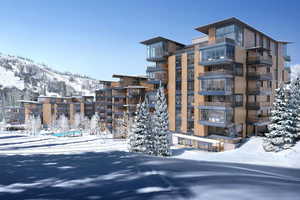 Snow covered building featuring a mountain view