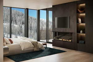 Bedroom featuring a wall of windows and light hardwood / wood-style floors