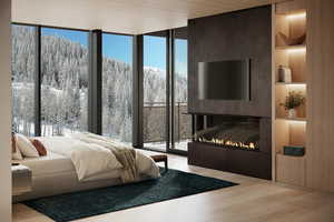 Bedroom with hardwood / wood-style flooring and expansive windows