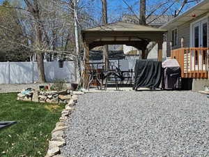 Exterior space featuring a gazebo and a deck, hot-tub