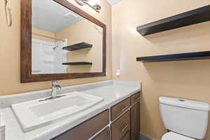 Master bathroom with a shower, visible vents, vanity, and toilet