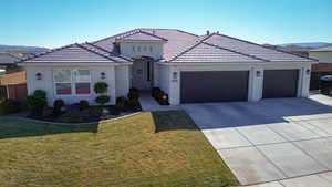 View of front of home with a garage and a front yard