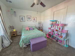 Bedroom featuring ceiling fan and dark carpet