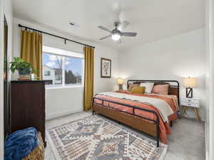 Bedroom featuring light colored carpet and ceiling fan