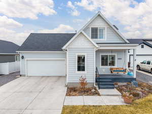 View of front of house with a garage and covered porch