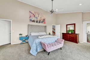 Carpeted bedroom featuring ceiling fan and ornamental molding