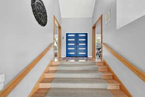 Stairs featuring french doors, plenty of natural light, and hardwood / wood-style floors