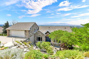 View of front of house with a garage and a mountain view