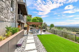 View of yard with a mountain view, a pergola, and a patio area