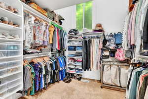 Walk in closet featuring carpet flooring