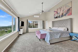 Bedroom featuring vaulted ceiling, carpet, and ceiling fan