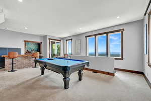 Game room with light colored carpet and billiards