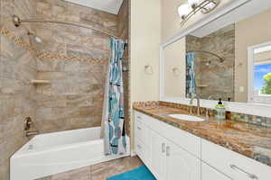 Bathroom with vanity and shower / bath combo with shower curtain