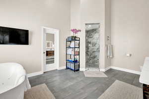 Bathroom with plus walk in shower and a towering ceiling