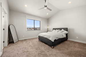 Bedroom with light carpet, vaulted ceiling, and ceiling fan